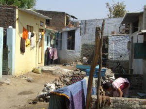 A slum where Saath works w/ paved roads, sanitation and electric meters. 
